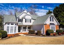 Charming two-story home with brick accents, well-manicured lawn, and inviting curb appeal at 2003 Hubbard Ct, Villa Rica, GA 30180