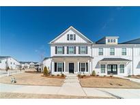 Charming two-story home with white siding, black shutters, covered entry, and well-manicured lawn at 1703 Prospect Way, Conyers, GA 30094