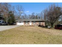 Charming brick home featuring a well-maintained front yard and a welcoming entrance at 147 Windy Hill Sw Rd, Marietta, GA 30060