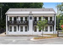 Beautiful two-story white building with black accents and a well-maintained parking area at 4856 Allatoona Gtwy # 8, Acworth, GA 30101