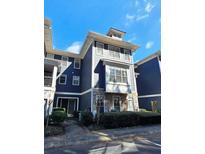 Beautiful townhouse with stone accents and manicured landscaping at 1575 Ridenour Nw Pkwy # 815, Kennesaw, GA 30152