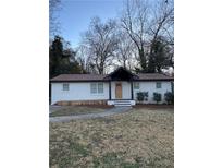 Charming, freshly painted home with a well-manicured front yard and inviting walkway at 3133 Rebecca St, Covington, GA 30014