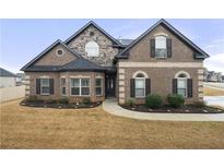 Charming brick home showcasing a manicured lawn and attractive landscaping for a welcoming curb appeal at 3492 Maple Hill Rd, Lithonia, GA 30038