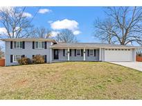 Charming single-story home featuring a well-manicured lawn and an attached two car garage at 2984 Bayard St, East Point, GA 30344