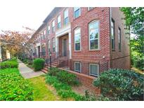 Traditional brick townhome with manicured landscaping and charming curb appeal at 2428 Crescent Park Ct, Atlanta, GA 30339