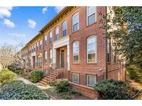 Brick townhomes showcase classic architecture with manicured landscaping and inviting entrances at 2428 Crescent Park Ct, Atlanta, GA 30339