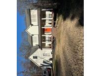 Charming two-story home featuring a welcoming front porch and an eye-catching orange front door at 281 Timber Laurel Ln, Lawrenceville, GA 30043