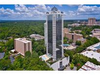 Stunning aerial view showcasing the high-rise condo with its pool and beautiful surrounding landscape at 2828 Peachtree Nw Rd # 903, Atlanta, GA 30305