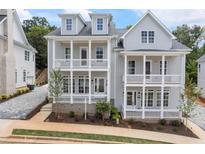 Charming two-story home with a double front porch and beautiful exterior paint at 2140 Parkside Ln, Roswell, GA 30076