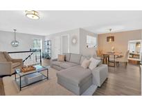 A cozy living room features modern gray furnishings and sleek hardwood floors at 1004 Lenox Ne Way, Atlanta, GA 30324