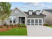 Charming single-Gathering home with a two-car garage, manicured lawn, and stone accents at 2040 Ripple Park Bnd, Canton, GA 30114