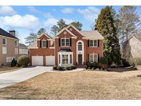 Charming two-story brick home with manicured lawn and a two-car garage at 4310 Red Rock Pt, Suwanee, GA 30024