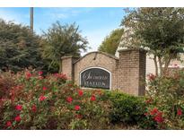 Southfield Station brick entrance sign surrounded by lush landscaping and flowering bushes at 1843 Grove Way, Hampton, GA 30228