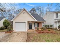 Charming single-story home with attached garage and well-maintained front yard landscaping at 132 Prity Ct, Mcdonough, GA 30253