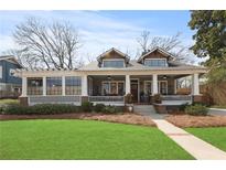 Charming two-story home with a covered porch, well-manicured lawn, and inviting curb appeal at 1518 Cambridge Ave, Atlanta, GA 30337
