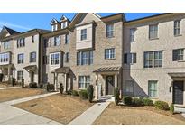 Charming brick townhouse with landscaped front and inviting entrance at 4362 White Spruce Aly, Doraville, GA 30360