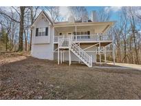 Charming home featuring a welcoming front porch and light gray exterior at 100 Nottingham Dr, Douglasville, GA 30134