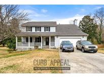 Charming two-story home with a welcoming front porch and attached two-car garage at 1710 Meadowchase Ct, Snellville, GA 30078