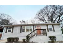 Charming single story home featuring wood accents, neutral siding and a brick foundation at 2215 Gordon Se Cir, Smyrna, GA 30080