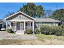 Charming home featuring a covered front porch, manicured landscaping, and classic architectural details at 69 Polar Rock Sw Rd, Atlanta, GA 30315