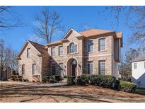 Stunning two-story brick home with a manicured front yard and arched entryway at 3735 Holiday Lane Ln, Atlanta, GA 30349