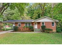 Charming brick home with a well-maintained lawn and mature trees, offering a cozy and inviting curb appeal at 2150 Meadowlane Dr, Atlanta, GA 30311