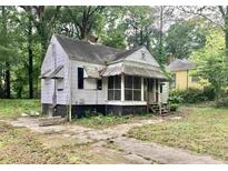 Classic home with a screened porch and a spacious yard surrounded by mature trees at 1840 Madrona Nw St, Atlanta, GA 30318