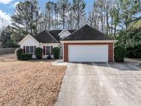 Charming one-story home with a well-maintained lawn and attached two car garage at 2577 Twin Oaks Sw Dr, Marietta, GA 30064