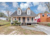 Charming two-story home with a welcoming front porch and well-maintained yard, perfect for relaxing outdoors at 2223 Wingate Sw St, Atlanta, GA 30310