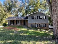 Charming two-story home with brick and gray siding, black shutters, a front porch, and a well-maintained lawn at 4045 Westview St, Douglasville, GA 30135