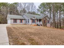 Charming single-Gathering home with stone accents, red shutters, and a well-manicured front lawn at 2935 Pruitt Rd, Cumming, GA 30041