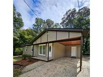 Charming single-story home featuring a carport, neutral siding and trim, and a well-maintained front yard at 6658 Collins Ct, Riverdale, GA 30274