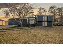 Contemporary home with a two-car garage and mature trees in the front yard at 2412 Renny Ct, Marietta, GA 30066