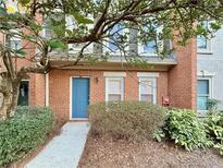 Charming brick townhome with a blue front door and mature landscaping at 3533 Mulberry Way, Duluth, GA 30096