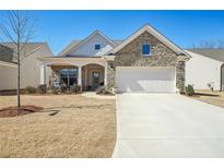 Charming single-Gathering home featuring a stone facade, two-car garage, and a cozy front porch at 2764 Bateman Sw St, Powder Springs, GA 30127