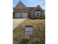 Charming home with a stone facade, two-car garage, and well-maintained lawn at 3121 Baywood Ct, Conyers, GA 30013