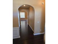 Inviting hallway with dark hardwood floors and arched entryway to other rooms at 3121 Baywood Ct, Conyers, GA 30013