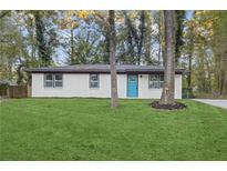 Charming exterior with freshly painted brick, modern windows and a vibrant blue front door at 612 Saddlewood Dr, Lawrenceville, GA 30043