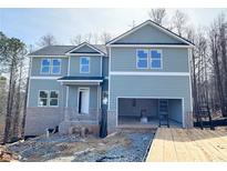 New two-story home features an attached two-car garage and inviting covered front entry at 66 Pine Creek Ct, Dallas, GA 30157