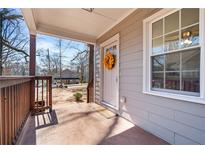Charming front porch featuring a decorative wreath, wood railings, and view of a neighborhing home at 1686 Terry Mill Se Rd, Atlanta, GA 30316