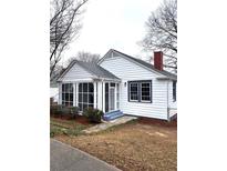 Charming home with a screened-in porch, gray-trimmed windows, and a brick chimney at 5091 Newark Ave, Clarkdale, GA 30111