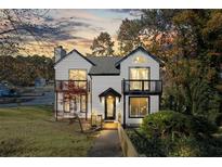 Charming two-story home with a manicured lawn and inviting front porch and balcony at 3798 Valley Brook Rd, Snellville, GA 30039
