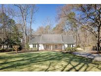 Charming single-story home featuring a well-manicured lawn and a welcoming entrance with double doors at 2190 Spalding Dr, Sandy Springs, GA 30350