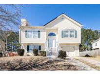 Well-kept two-story home featuring a manicured front yard and ample parking at 4415 Roche St, Atlanta, GA 30349