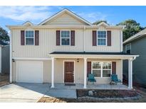 Charming two-story home with a welcoming front porch and a well-maintained lawn at 5987 Westchase St, Atlanta, GA 30336