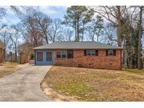 Charming brick home with a well-maintained front yard and a long driveway at 3553 Lakeview Dr, Rex, GA 30273