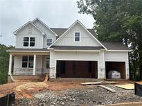 New construction home with a two-car garage with unfinished landscaping at 385 Riverwood Pass, Dallas, GA 30157