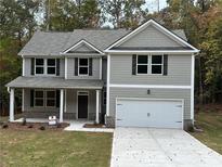 Charming two-story home with gray siding, black shutters, and a two-car garage at 1102 Campbell Rd, Covington, GA 30014