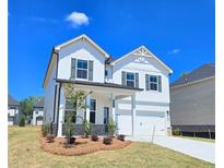 Beautiful two-story home with white siding, dark shutters, and a well-manicured lawn at 2634 Mourning Dove Drive (Lot 41), Grayson, GA 30017
