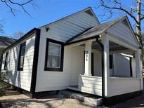 Charming home featuring white siding, black trim, and a welcoming covered front porch at 386 Sawtell Se Ave, Atlanta, GA 30315